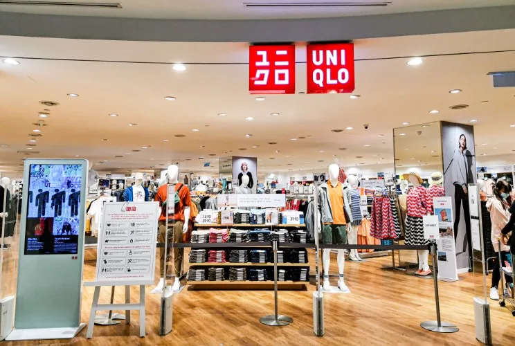 Uniqlo storefront with clothes displayed outside
