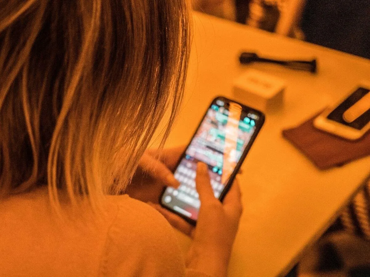 person using a phone while texting on whatsapp