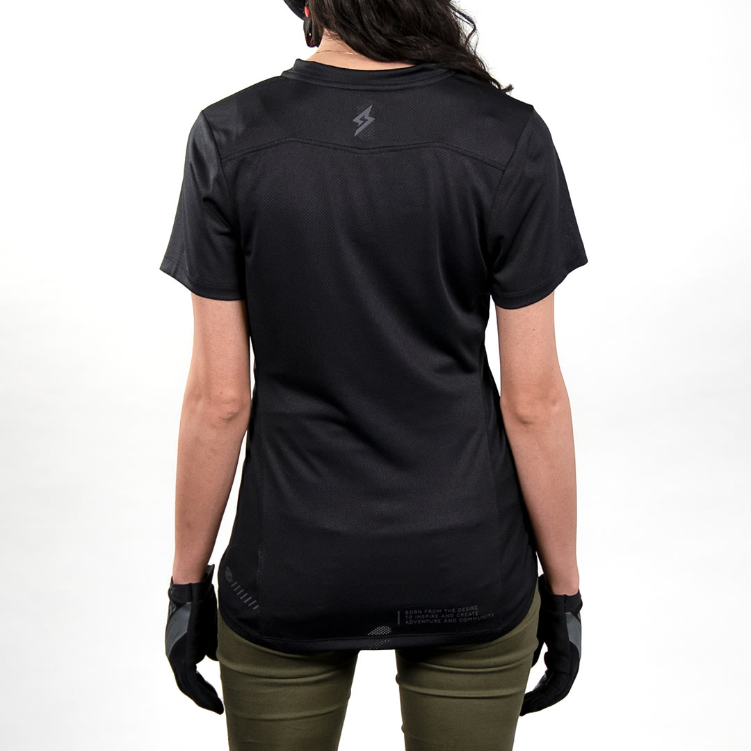 Back view of female model wearing 100% x Super73 Ridecamp Women's Jersey.