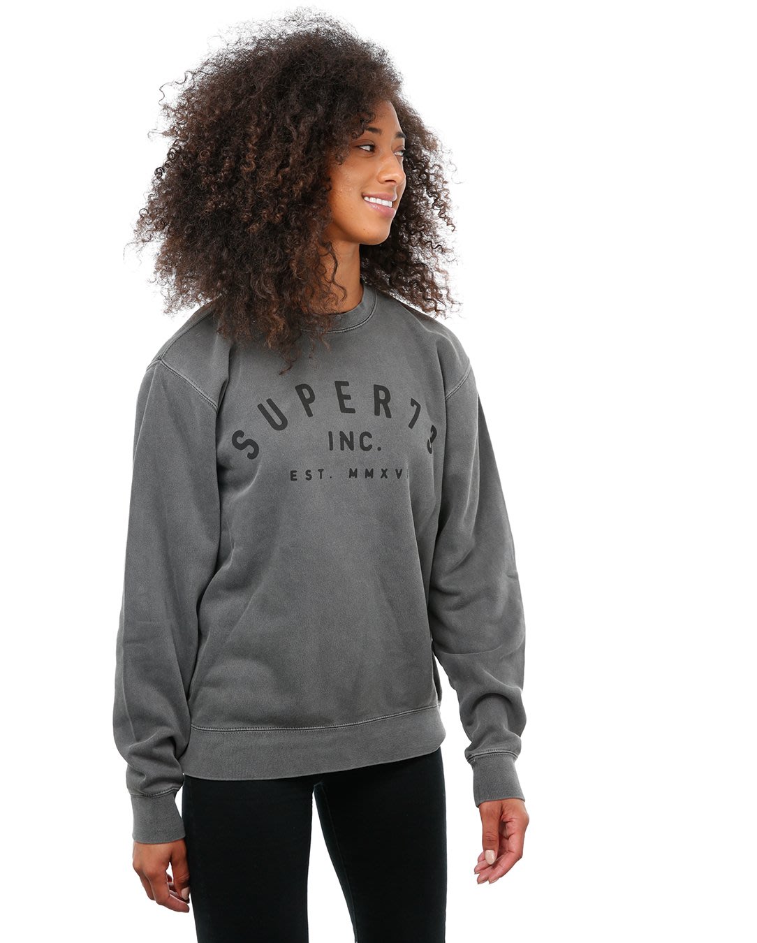 Front view of female model in Pigment Black Classic Crew Sweatshirt on white background.