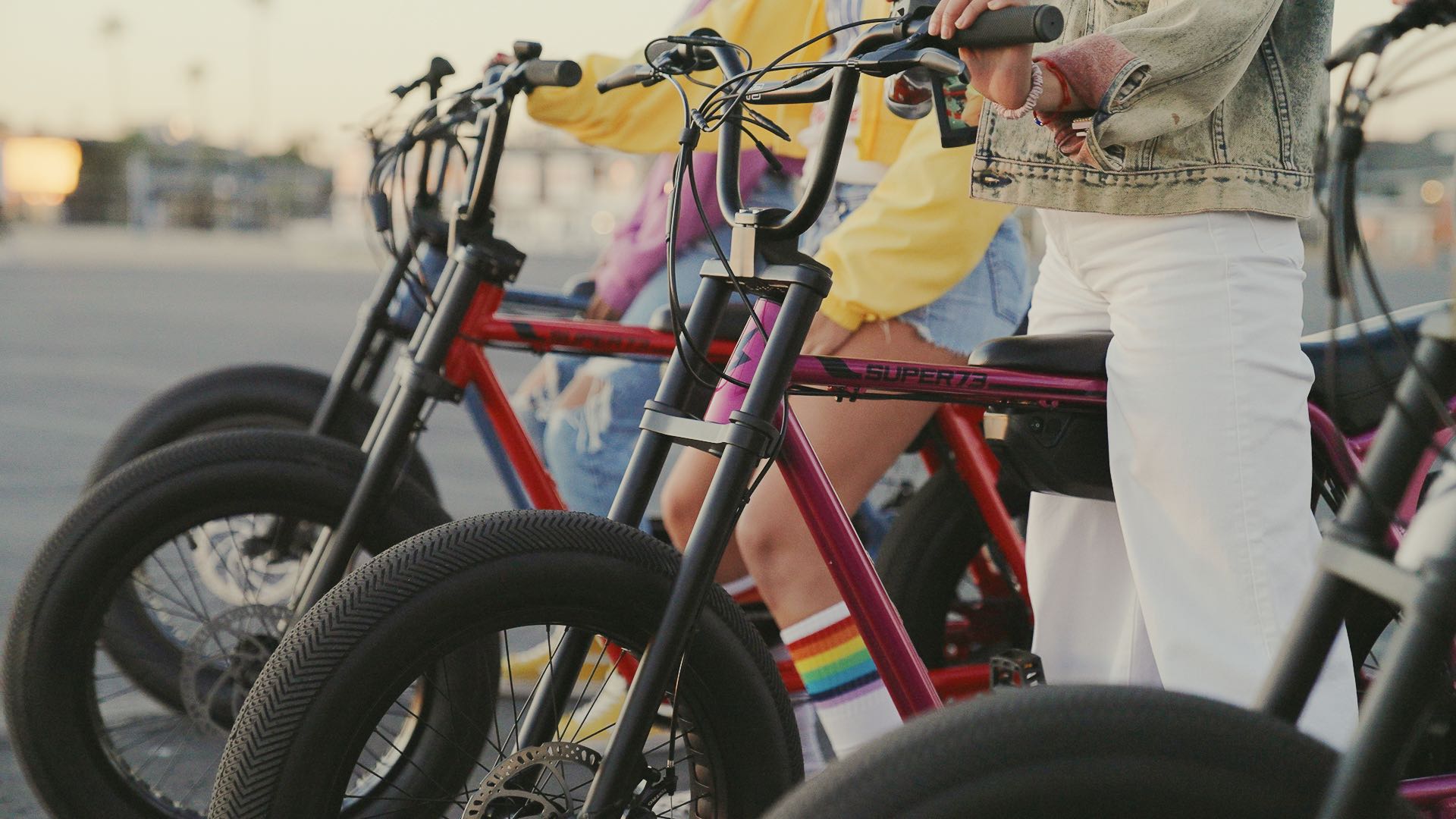 Closeup of the red, pink and blue Z Miami bikes lined up ready to ride