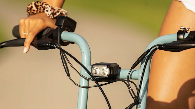 large-Super73 MustHaveAcc Safety Closeup of handlebar with attached light, bell and brakes.