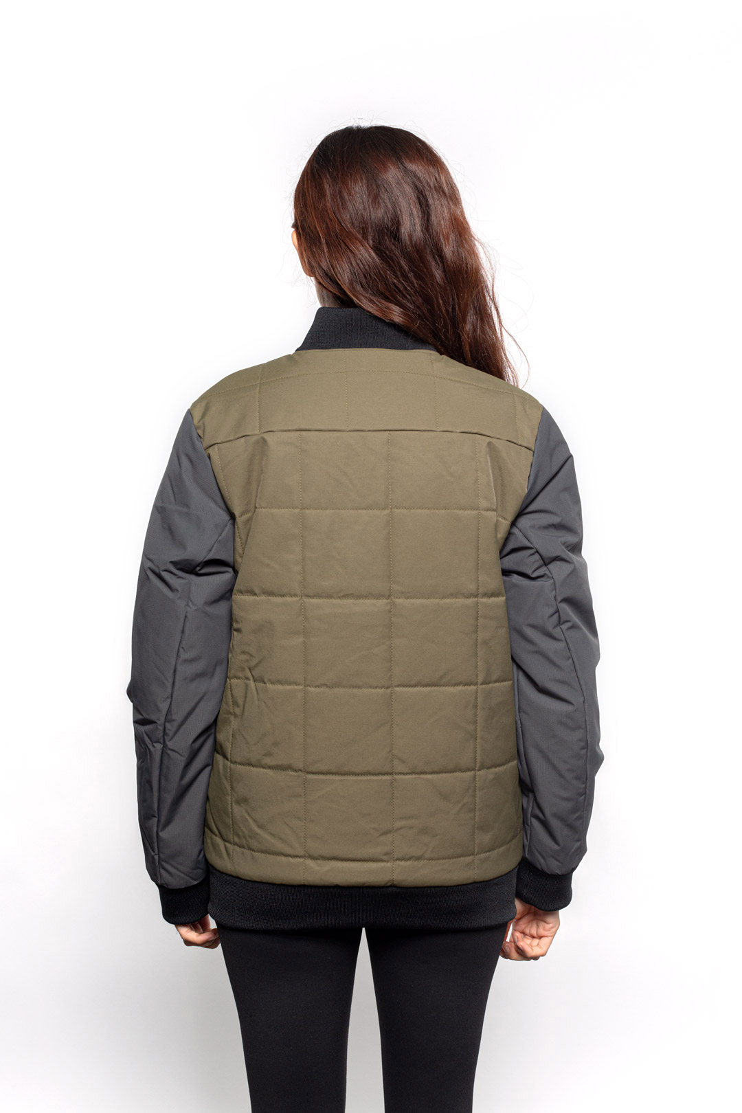 Back view of Female model wearing Sipes Varsity Jacket in dark fatigue colorway.
