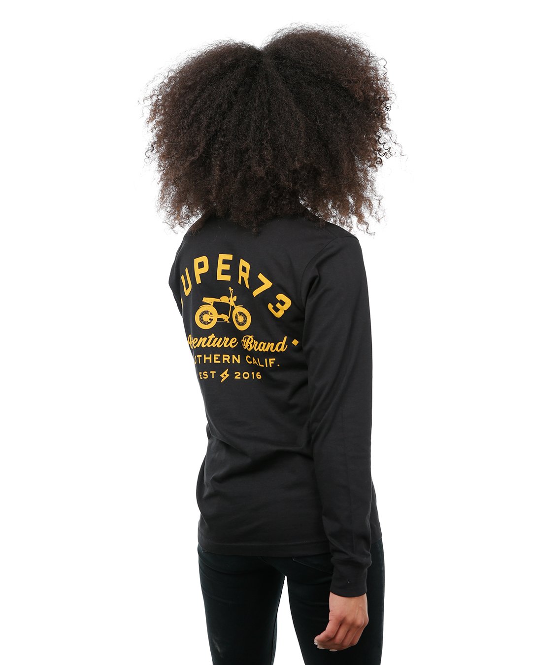 Side view of female model in Black Adventure Long Sleeve T-Shirt on white background.