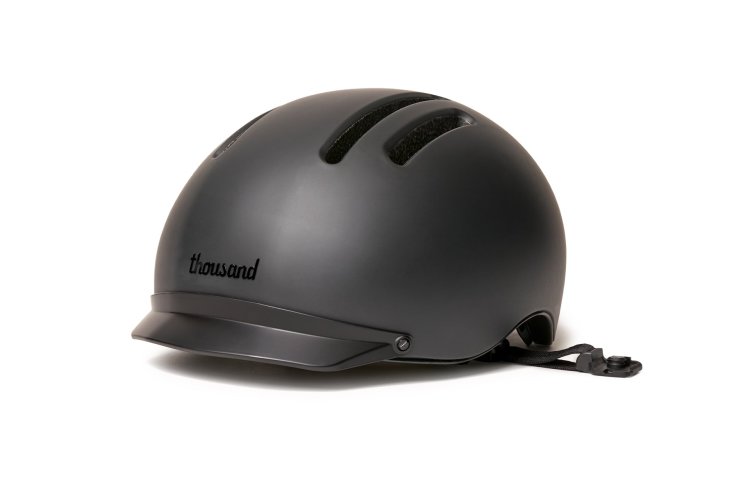 Black Chapter MIPS Helmet by Thousand with black visor on white background.