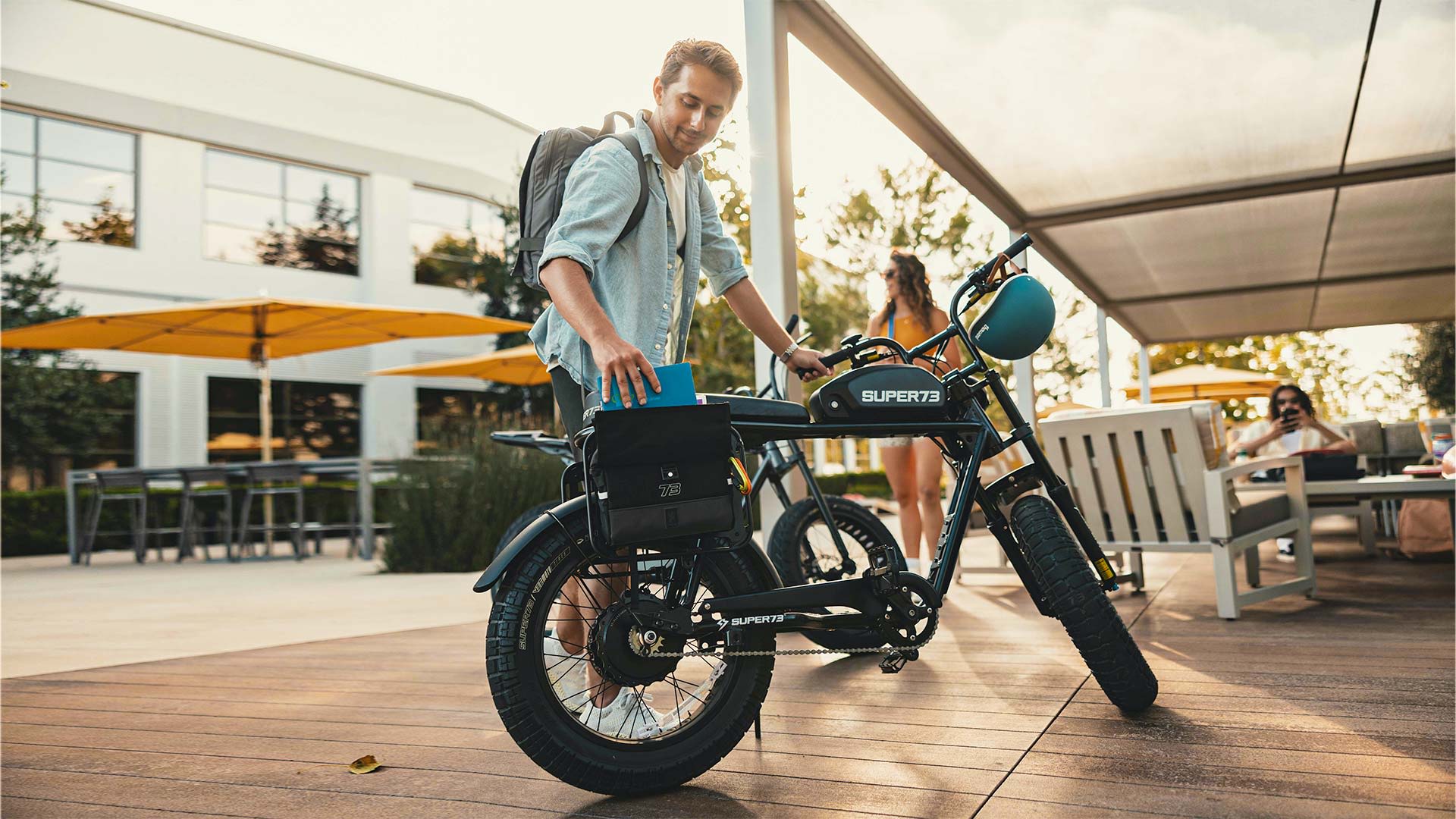 A lifestyle image of a student on campus packing up and heading home on his Super73 S2.