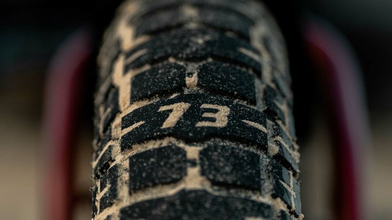 Closeup of sandy badger tire with 73 stamp tread