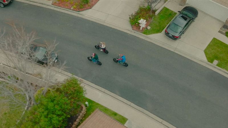 Super73 ZX ContentCard Range Aerial view of three friends riding SUPER73-ZX's on the streets of a suburban neighborhood.