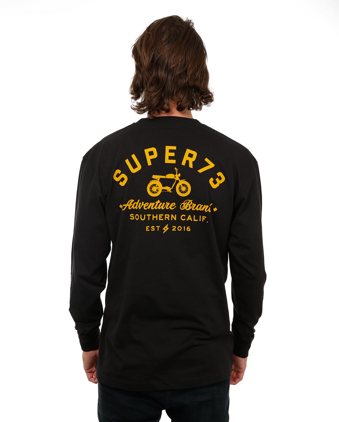 Back view of female model in Black Adventure Long Sleeve T-Shirt on white background.