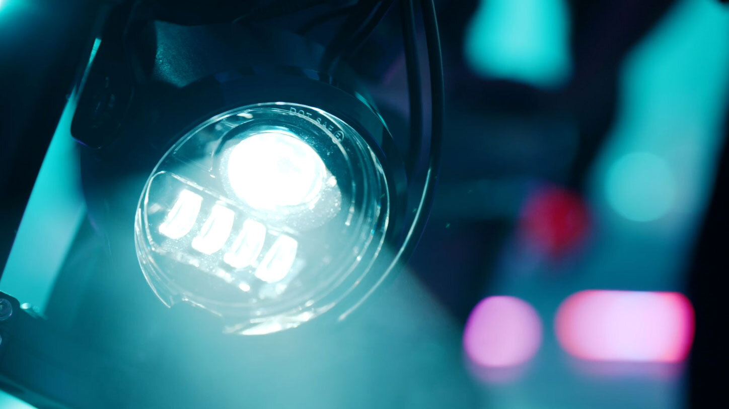 Closeup of a headlight shining through disco lights