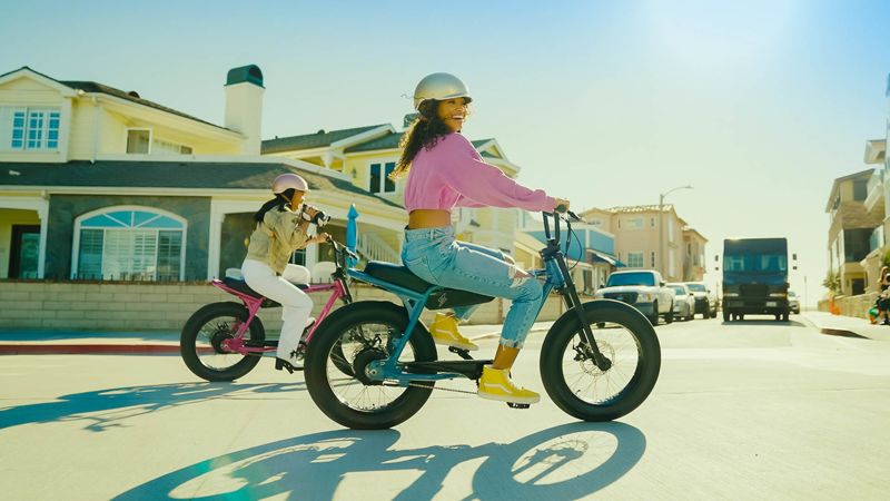 Two friends riding Z-series ebikes through a neighborhood 