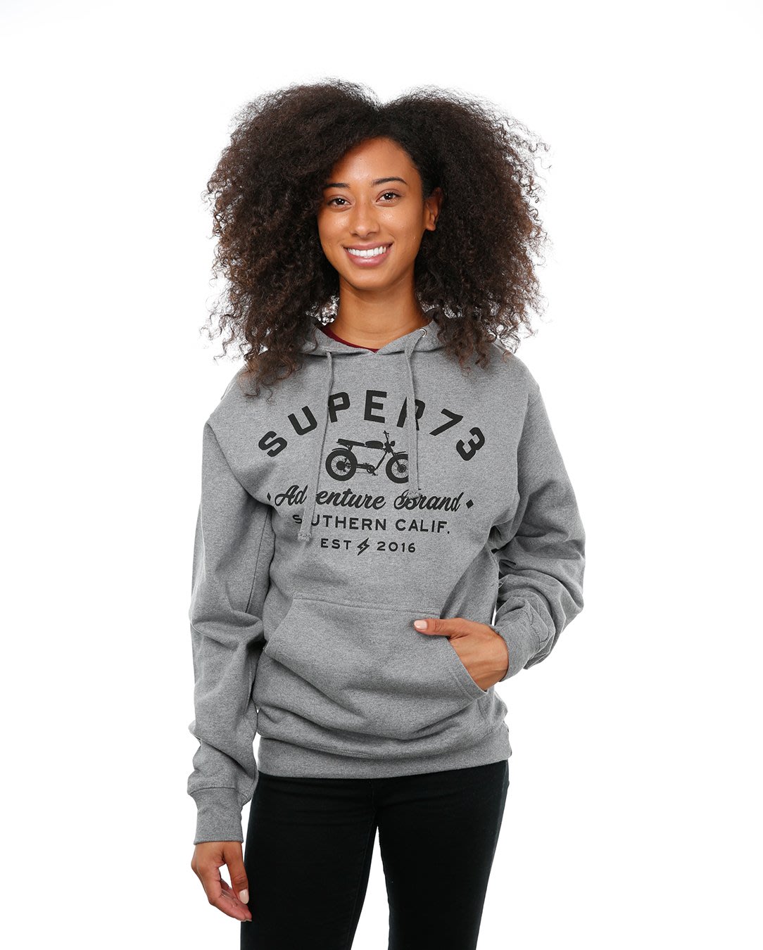 Front view of female model in Adventure hoodie on white background.