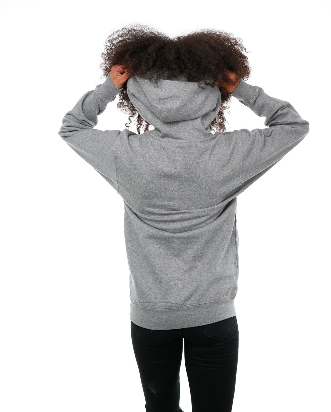 Back view of female model in Adventure hoodie on white background.