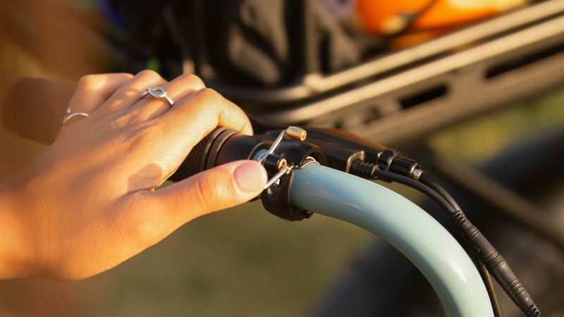 Bell attached to left handlebar showing how you can ring it with your left thumb