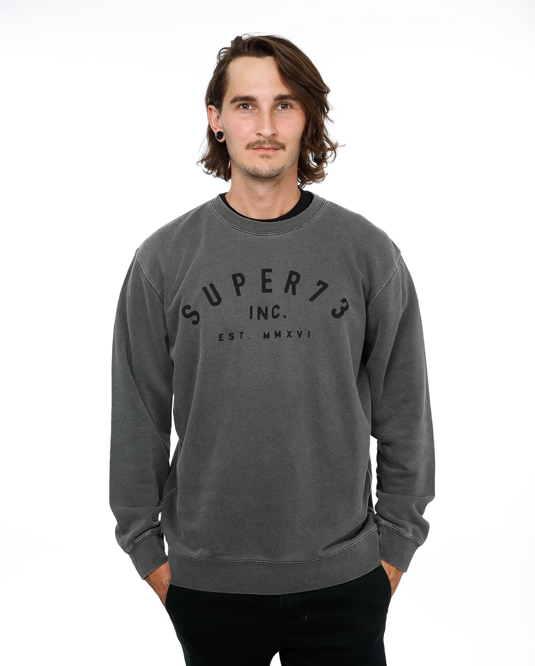 Front view of male model in Pigment Black Classic Crew Sweatshirt on white background.