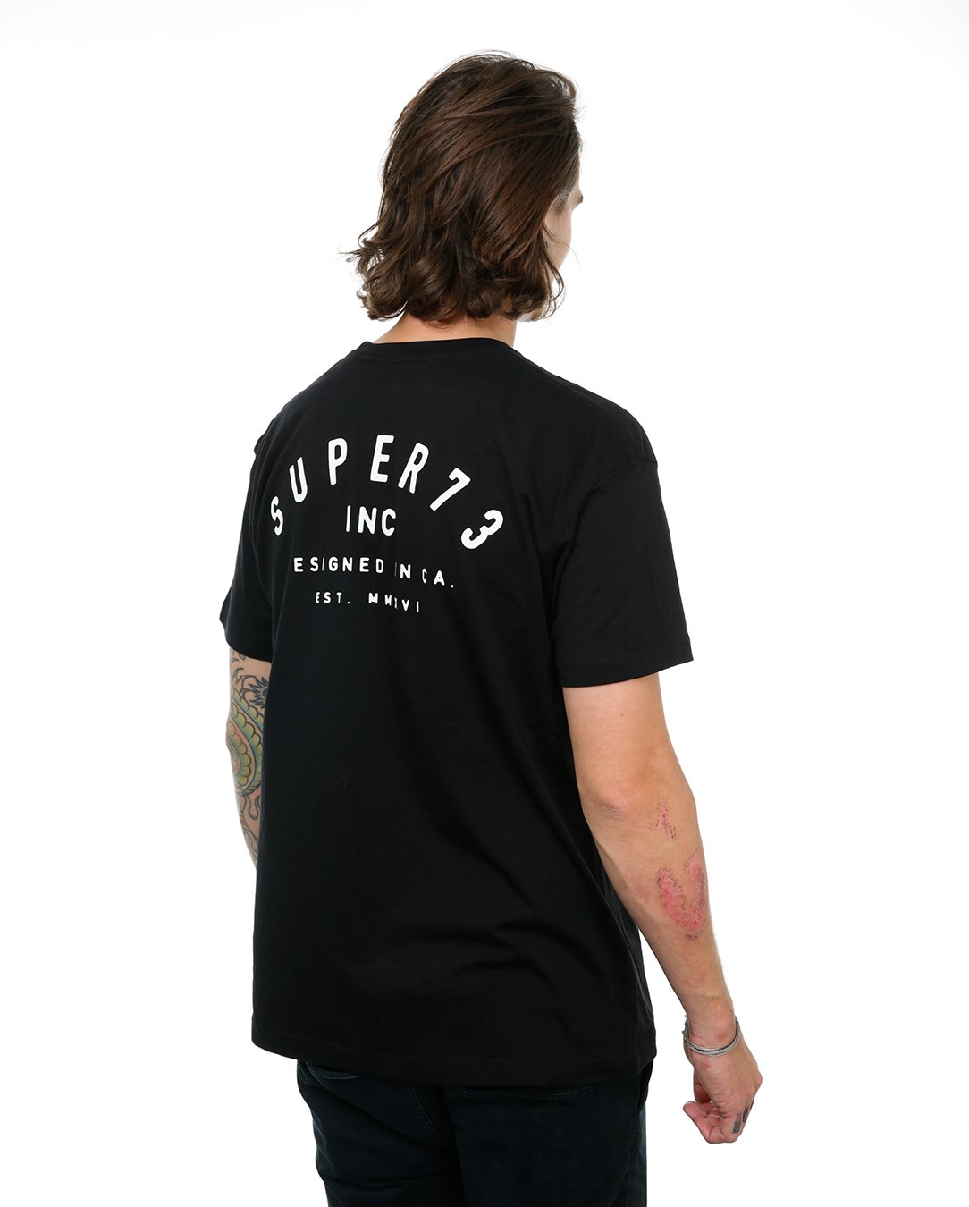Side view of male model in Black Classic Short Sleeve T-Shirt on white background.