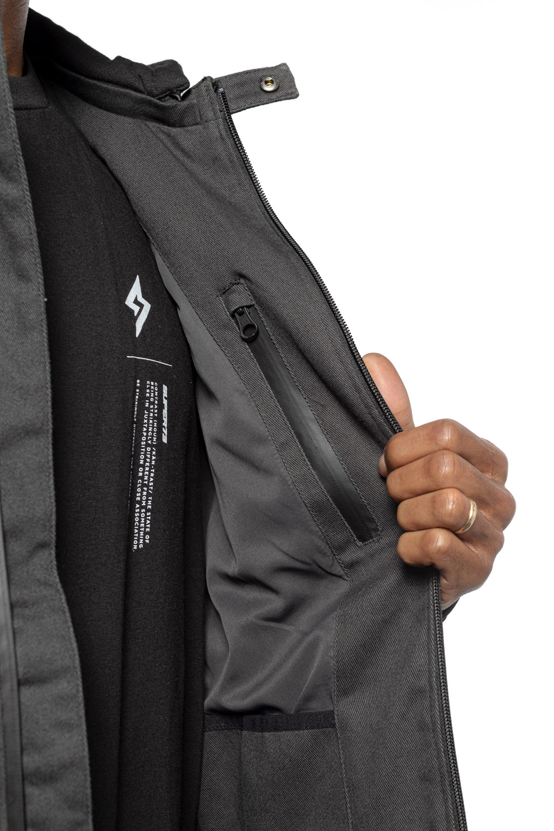 Male model showing inner details of Chisel Hooded Jacket in gravel colorway.