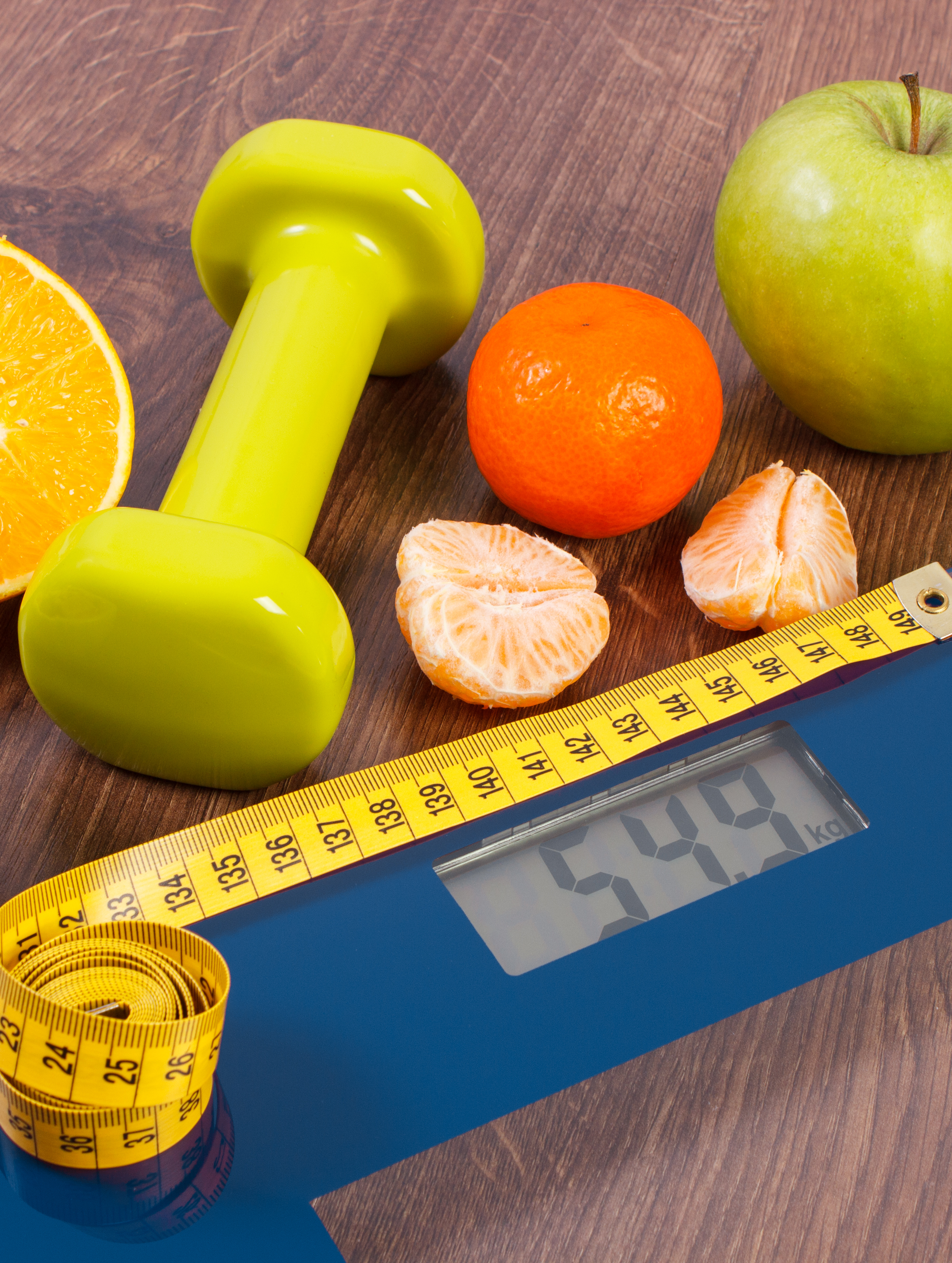 GLP-1 weight loss treatment concept with bathroom scales and a measuring tape