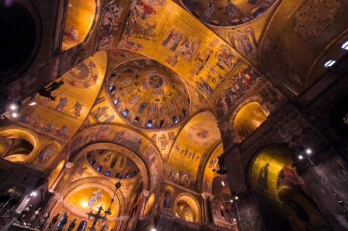 The tiles of St Mark's Basilica lit up at night on our Alone In St Mark's Basilica Tour