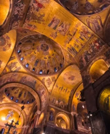 The tiles of St Mark's Basilica lit up at night on our Alone In St Mark's Basilica Tour