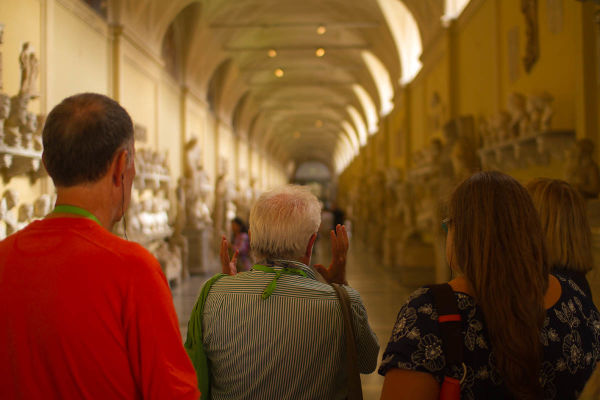 A guide leads a small tour group in the Vatican Museums after hours