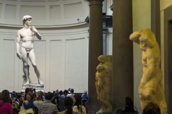 Michelangelo's David stands proudly in front of the tortured artist's unfinished 'Slaves'