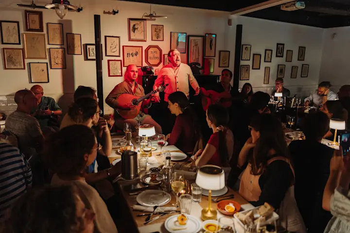 A group enjoys dinner and a fado show in Lisbon.