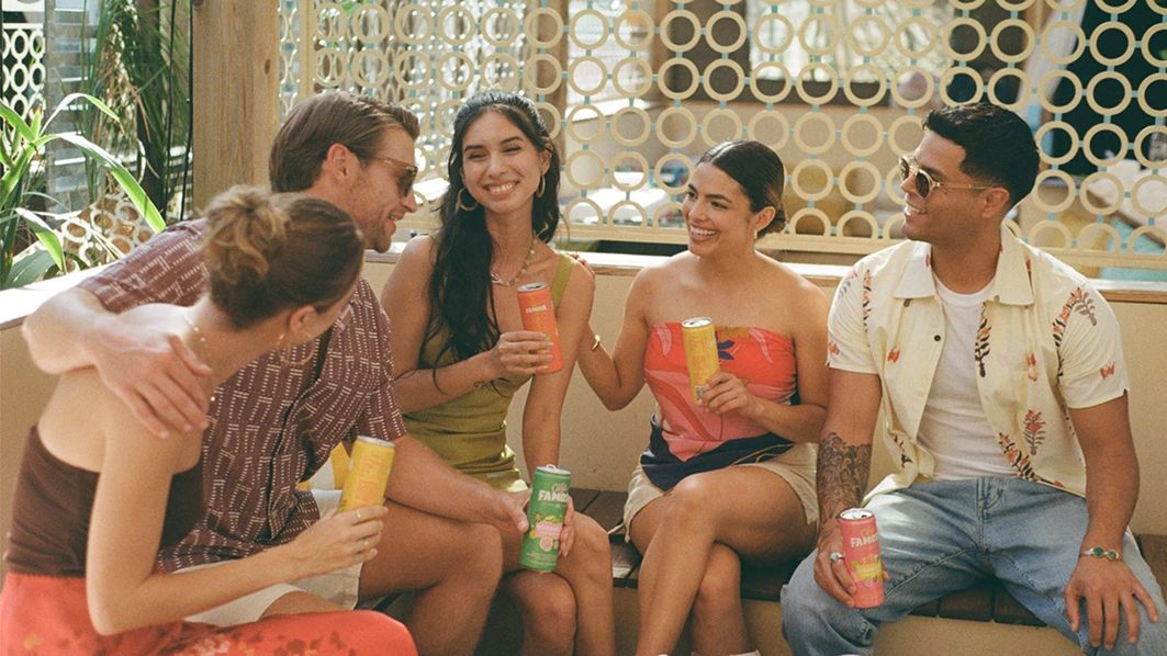 A group of people sitting together and enjoying Casa Famosa Hard Soda