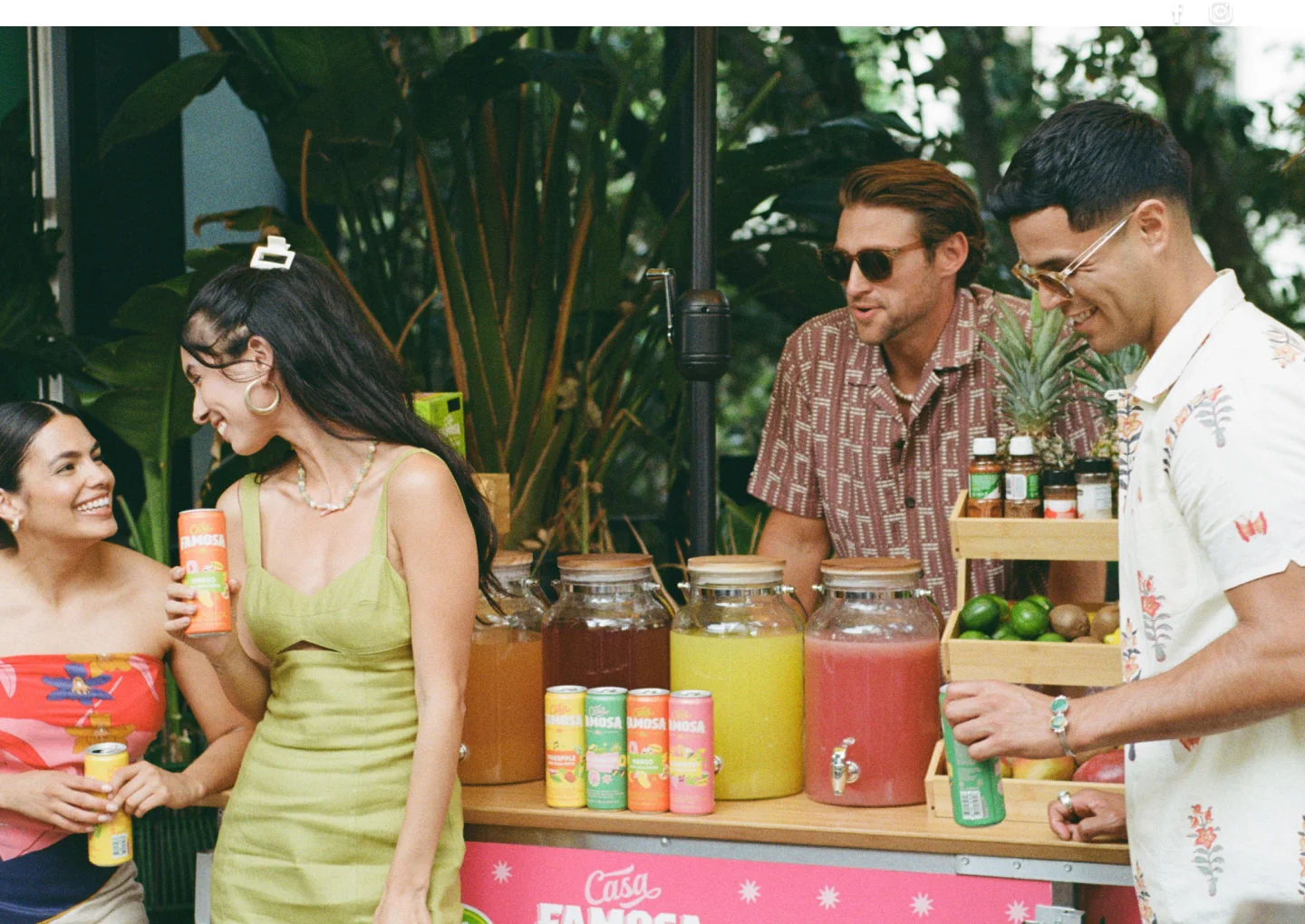 Group of friends sitting together, with Casa Famosa drinks visible on the table