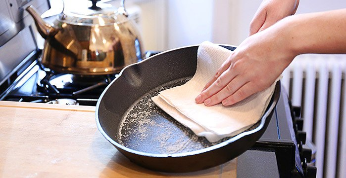 Woman wiping cast iron with Bounty Paper Towel