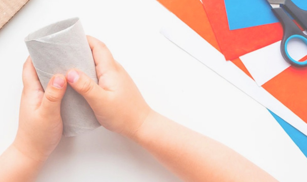 Young kid's hands holding an empty roll