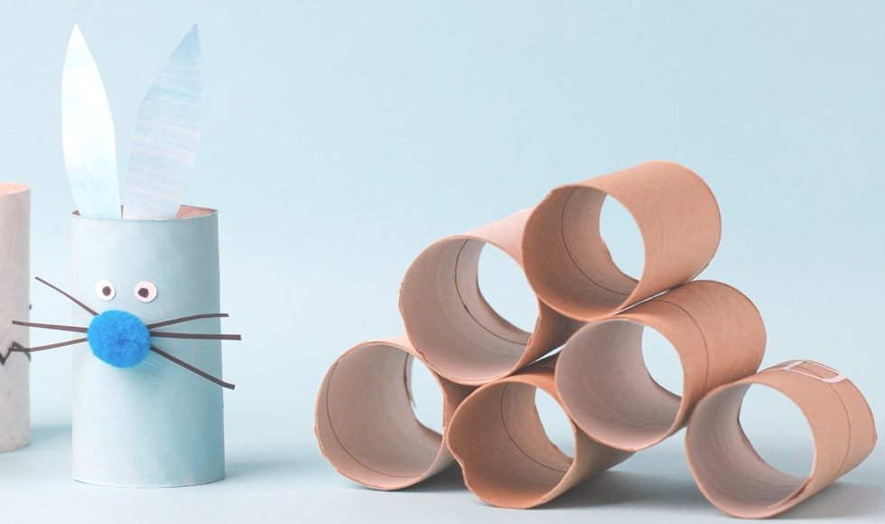 Bunny rabbit paper towel craft next to a stack of empty rolls