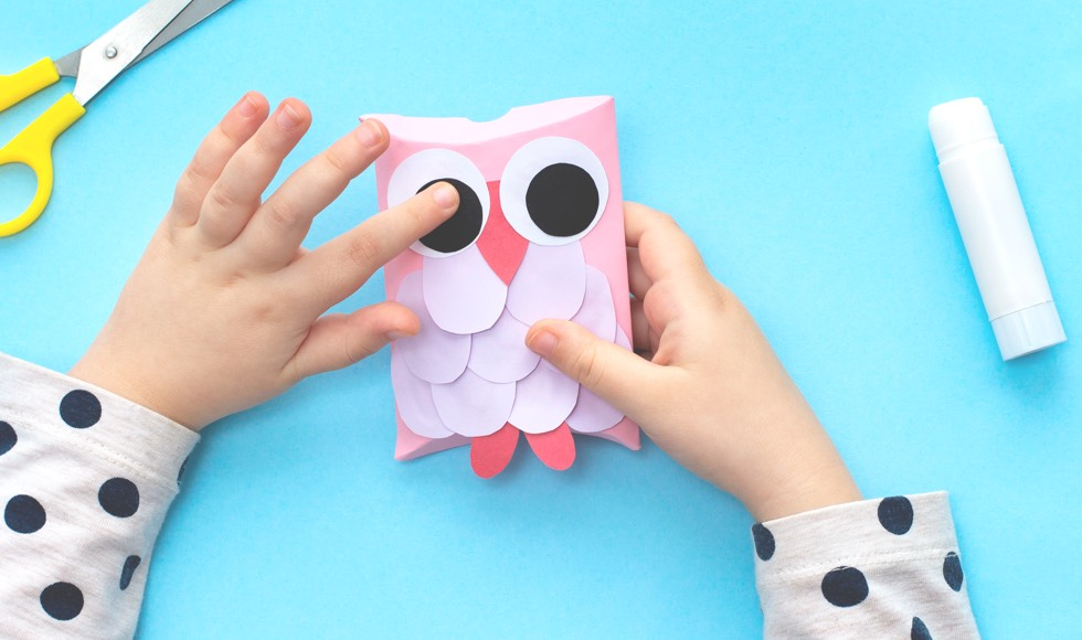 Young girl holding a Owl paper towel craft