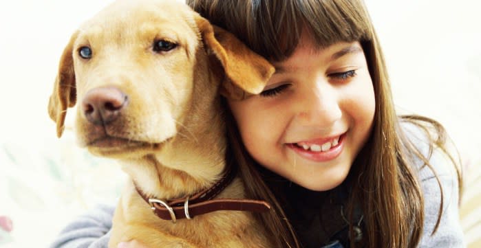 Young girl hugging a dog