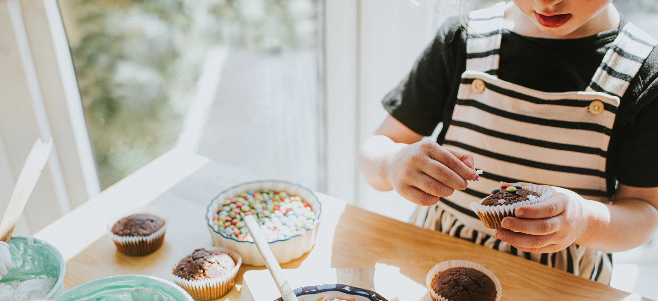 Kid decorating cupcake