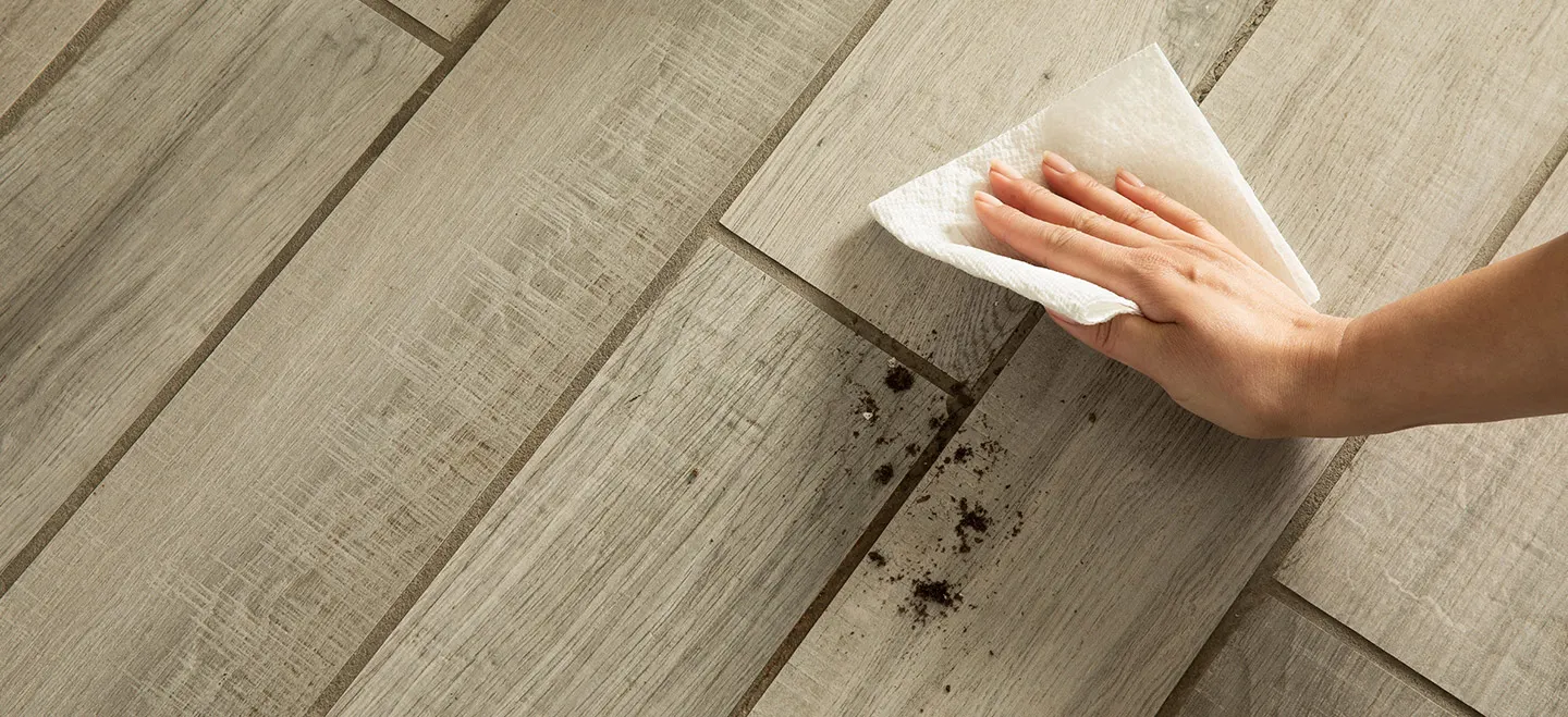 Woman wiping dirt off the floor  
