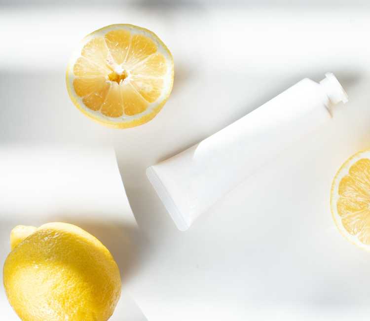 Lemons with a white tube of acyclovir cream.