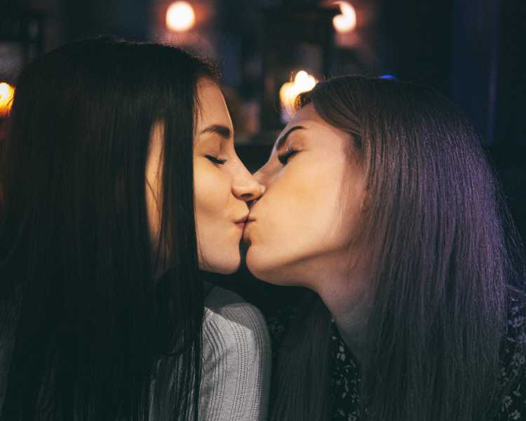 Girls combating cold sores with cold sore medication, kissing.