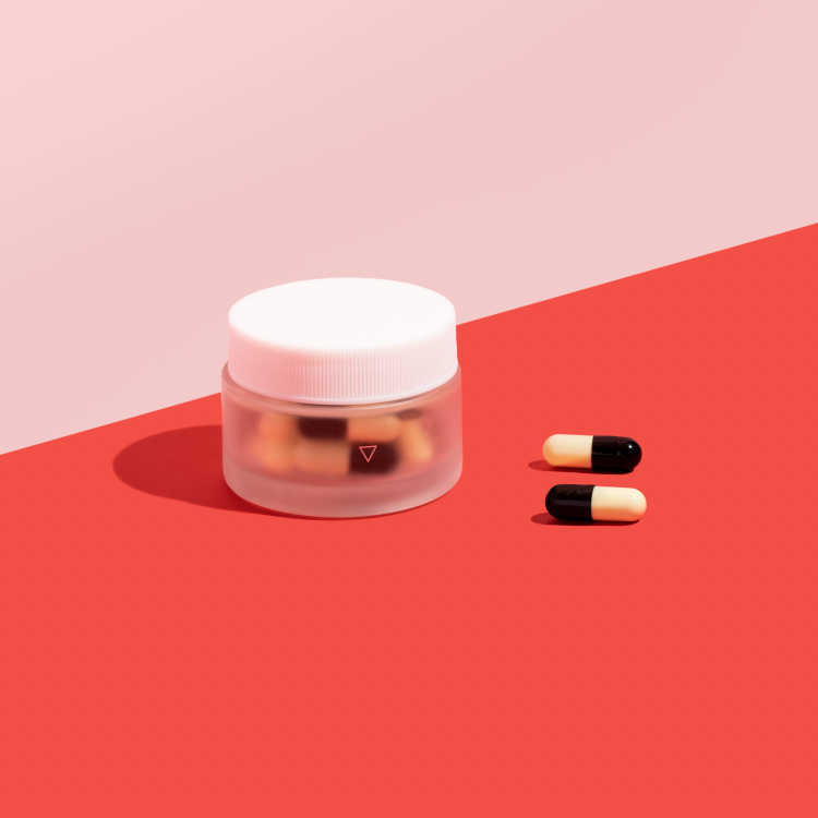 short jar of UTI antibiotics with two pills