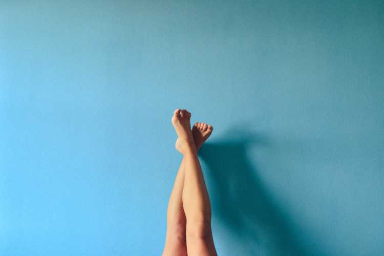 a person's legs against blue background