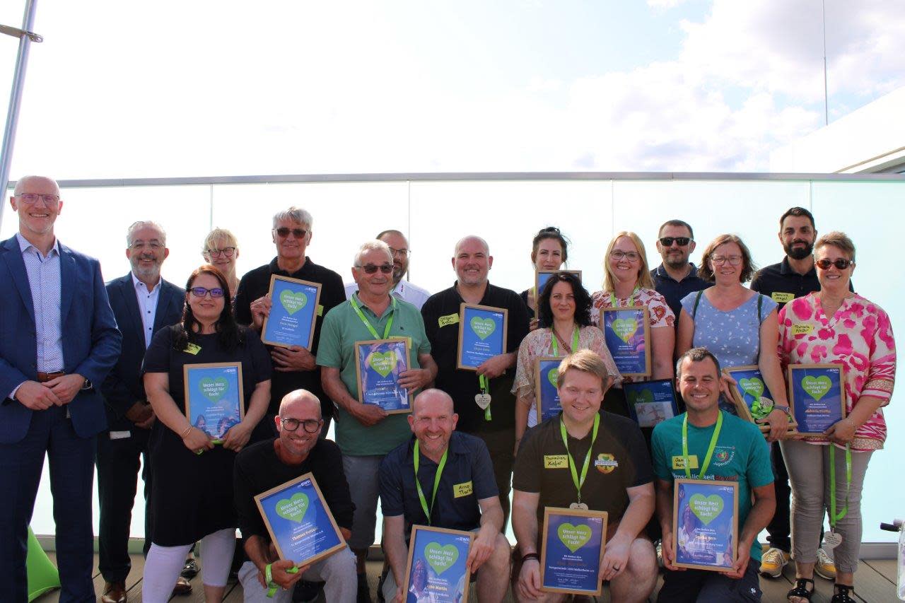 Titelbild Die EWR-Herzensmenschen halten eine Urkunde in der Hand und tragen eine Medaille