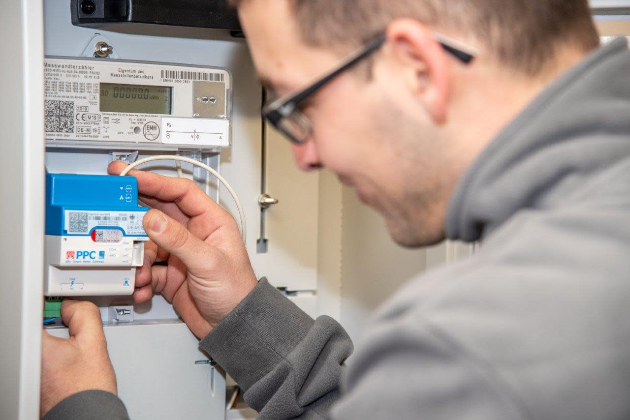 Ein moderner Stromzähler mit Kommunikationsmodul wird eingebaut Ein moderner Stromzähler mit Kommunikationsmodul wird eingebaut