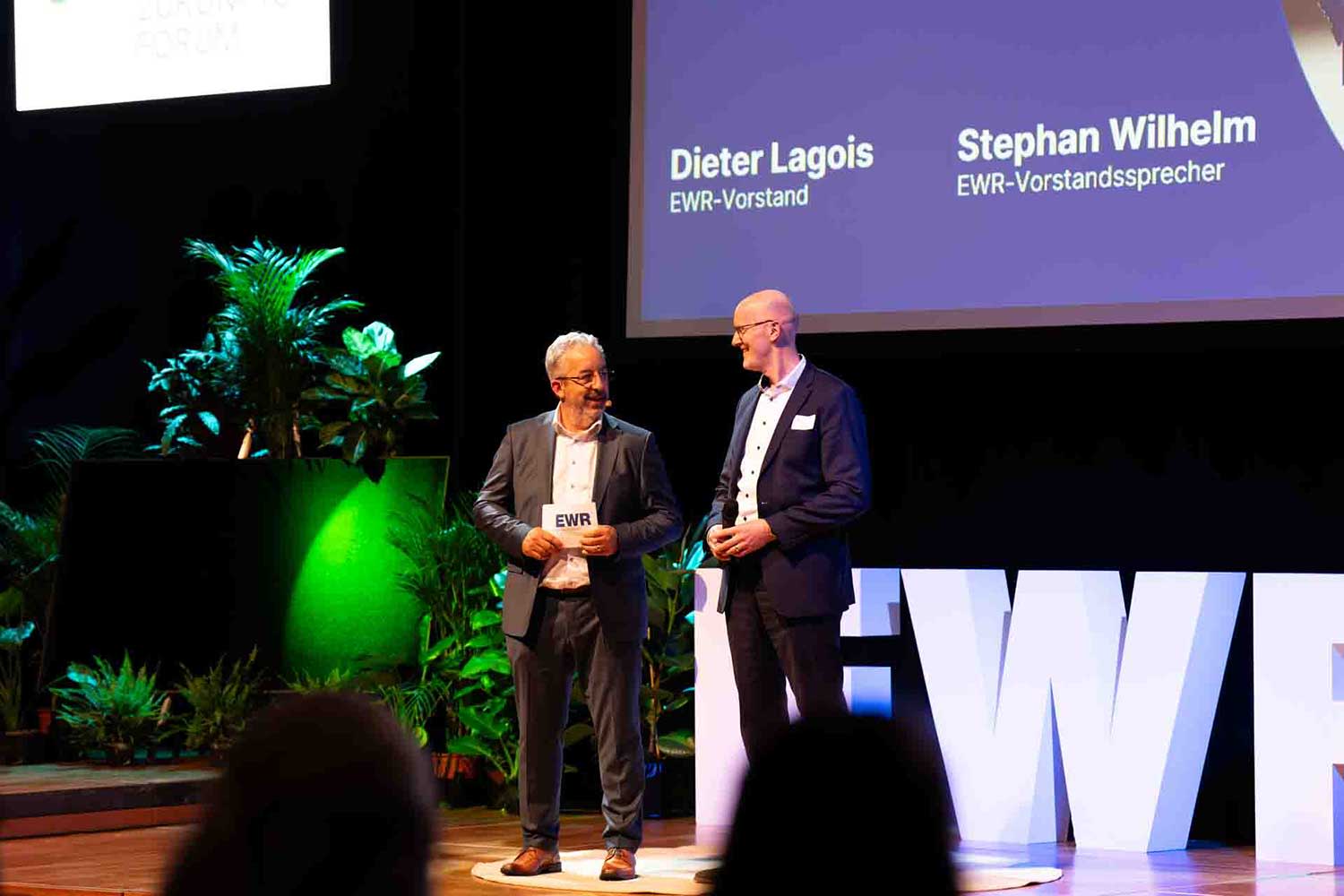 EWR-Vorstände Stephan Wilhelm und Dieter Lagois stehen auf der Bühne EWR-Vorstände Stephan Wilhelm und Dieter Lagois stehen auf der Bühne