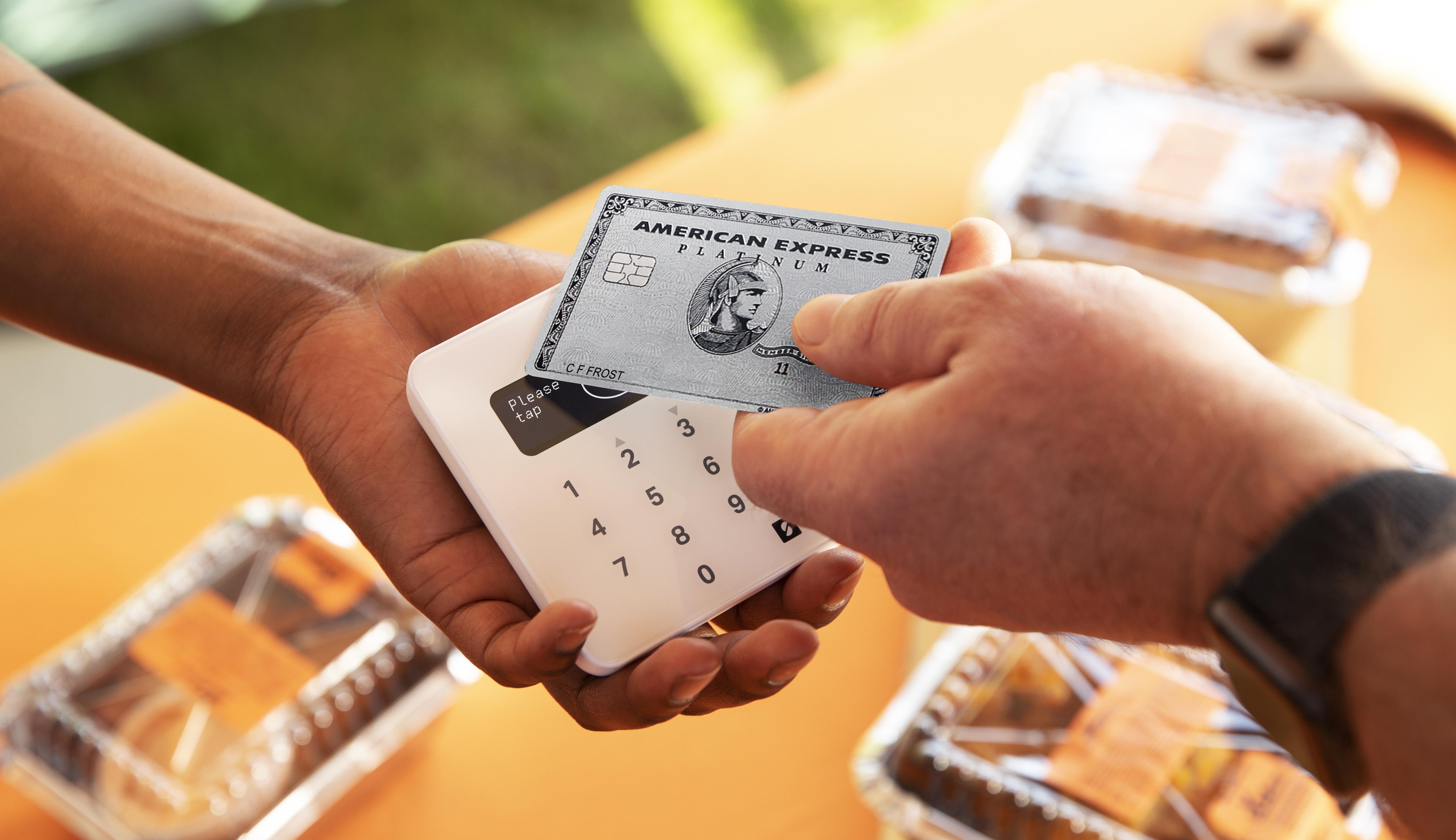 Customer paying for food with a credit card on a SumUp mobile card reader.