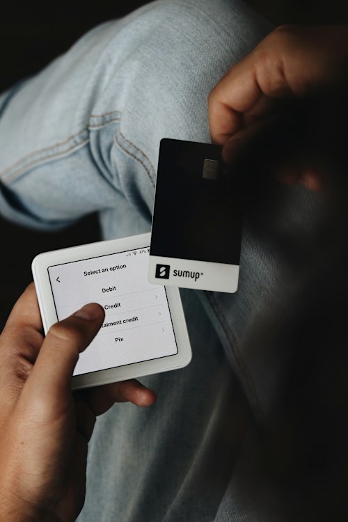 A business owner using his SumUp credit card to make a payment.