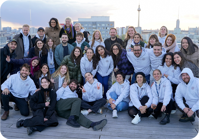 Photo of SumUp's Global Marketing team on the rooftop of the Berlin office with a view of the city on the background