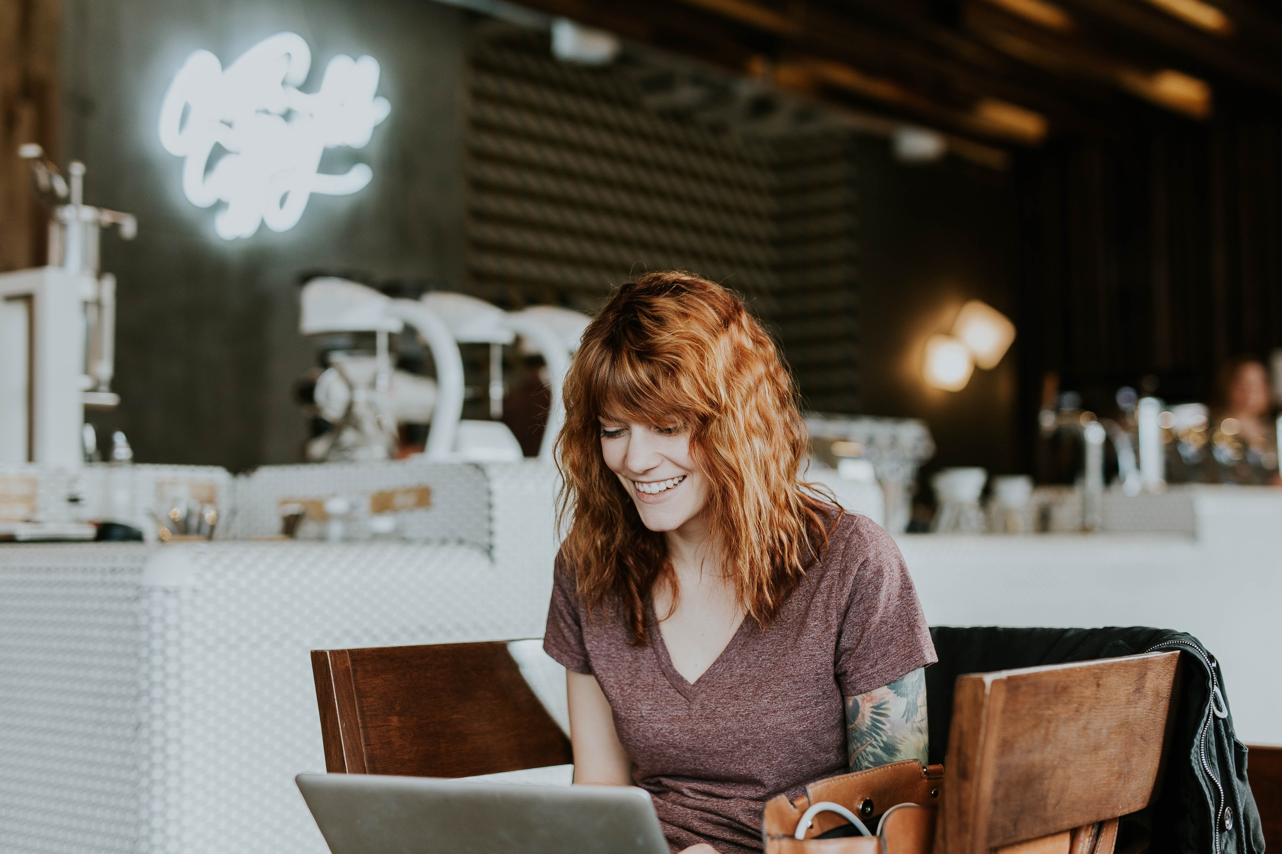 A woman creates an invoice on her laptop.