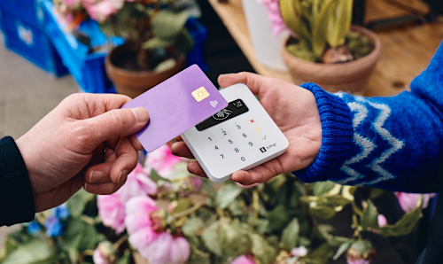 Customer paying for flowers with their card on a SumUp card reader