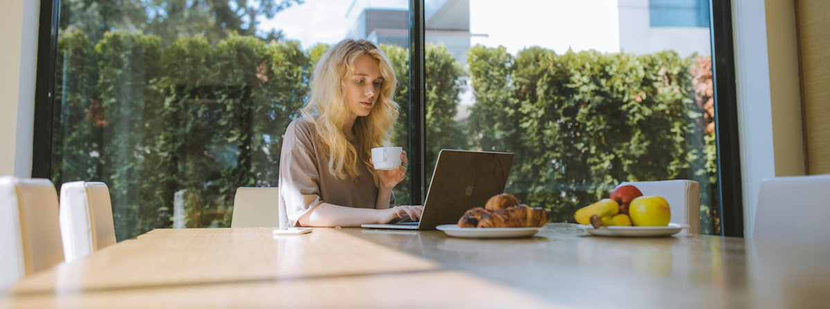 Frau mit Mitarbeiter Benefits wie Obst am Tisch.