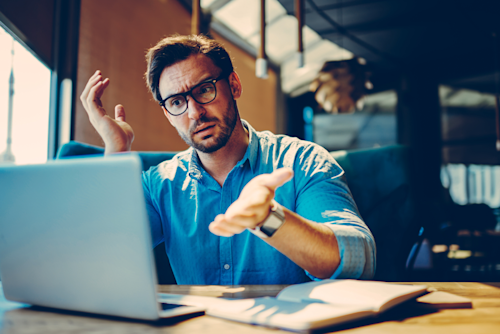 Stressed businessman trying to solve a problem on his laptop.